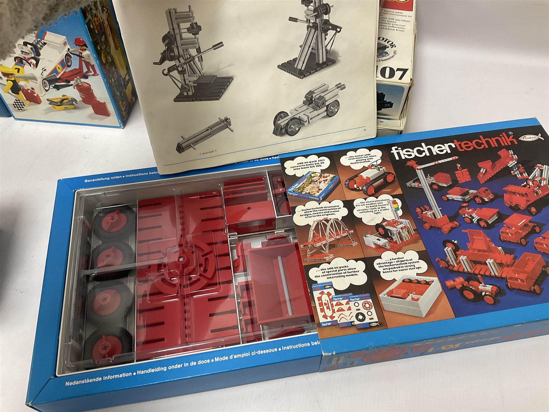 Fischer Technik/Lego/Playmobil - thirteen model building sets comprising eight Fischer Technik sets 50, 50/1, 50v, 50/2, 50+mot1 and two 50S, 50/1 add-on pack, with spare parts packs 01, 03, 05, two 22 and 30; two Lego sets comprising C107 and Lego Systems 103, part-set 870 and 970; Playmobil no.3520 set; four boxes of loose lego, various instruction manuals and a scrapbook 