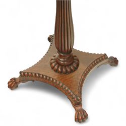 William IV mahogany folding card table of unusually small proportions, rectangular swivel top with gadrooned edge, raised on a slender tapered reeded column over quatreform base with gadrooned border, terminating in carved lion paws feet