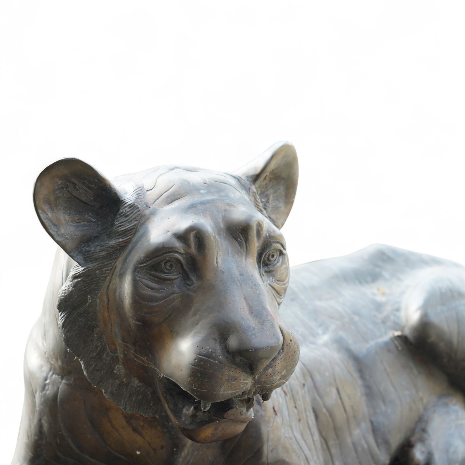 Pair of Chinese cast bronze tiger figures, one in a seated resting pose and the other advancing with open mouth, both with incised striping and aged bronze patina
Seated tiger (H 54cm, W 63cm, L 129cm)
Stood tiger (H 76cm, W 40cm, L 176cm) 