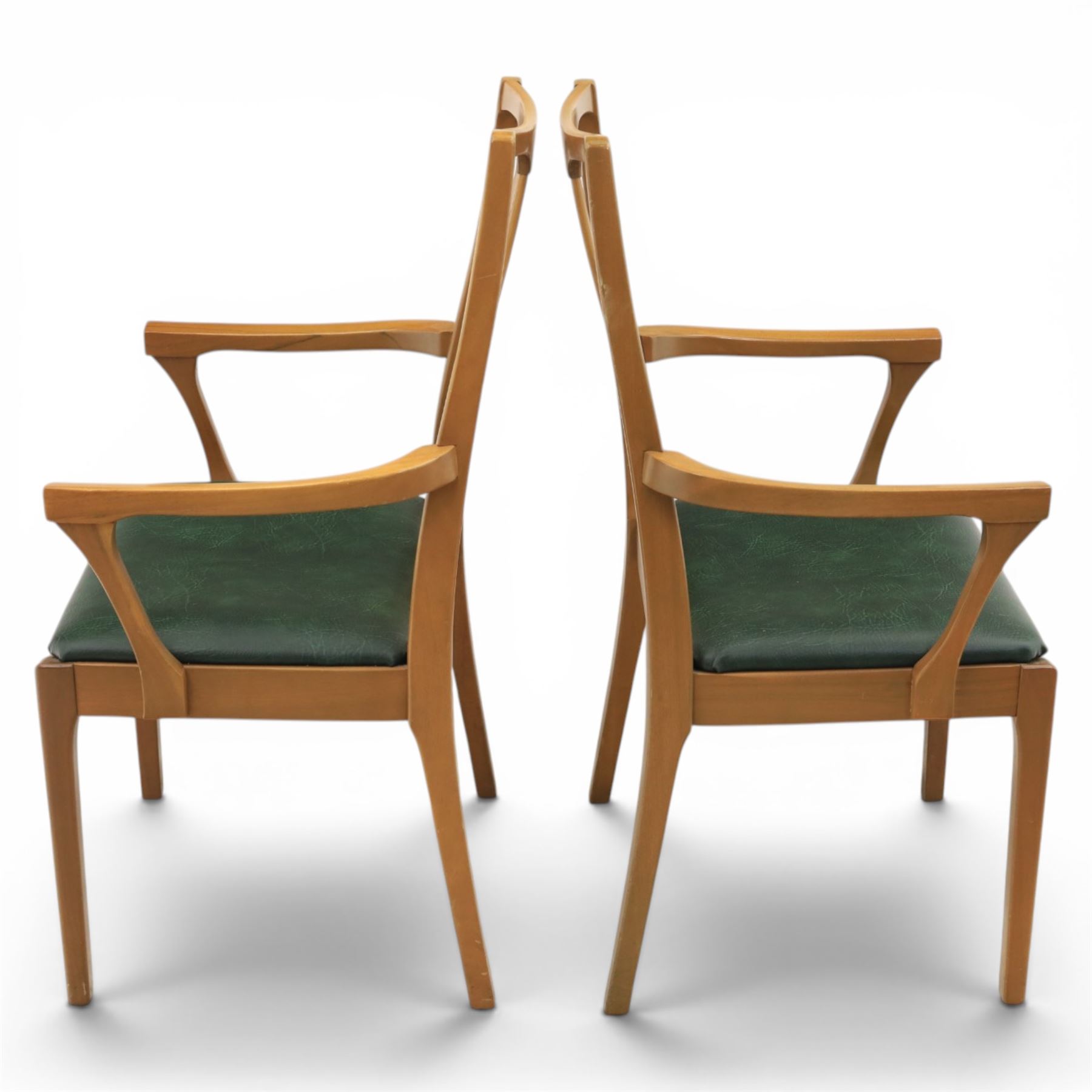 A pair of Nathan 'Highback Carvers' and a 20th century nest of teak tables, (Tables W65cm, D38cm, H49cm)
(Carvers W57, H97)