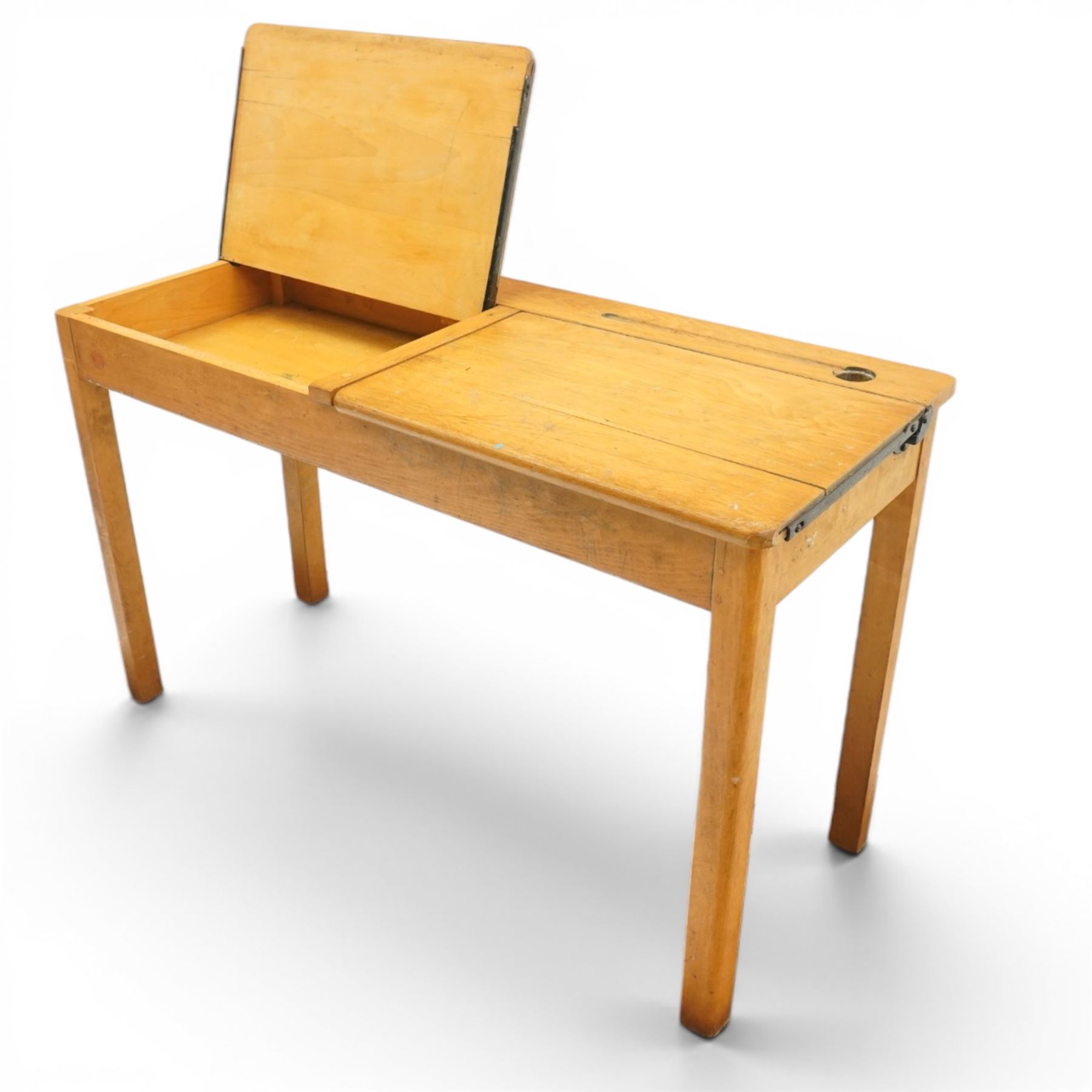 Mid-20th century beech double school desk, twin hinged desk-top compartments with inset pen and ink tray, on square supports