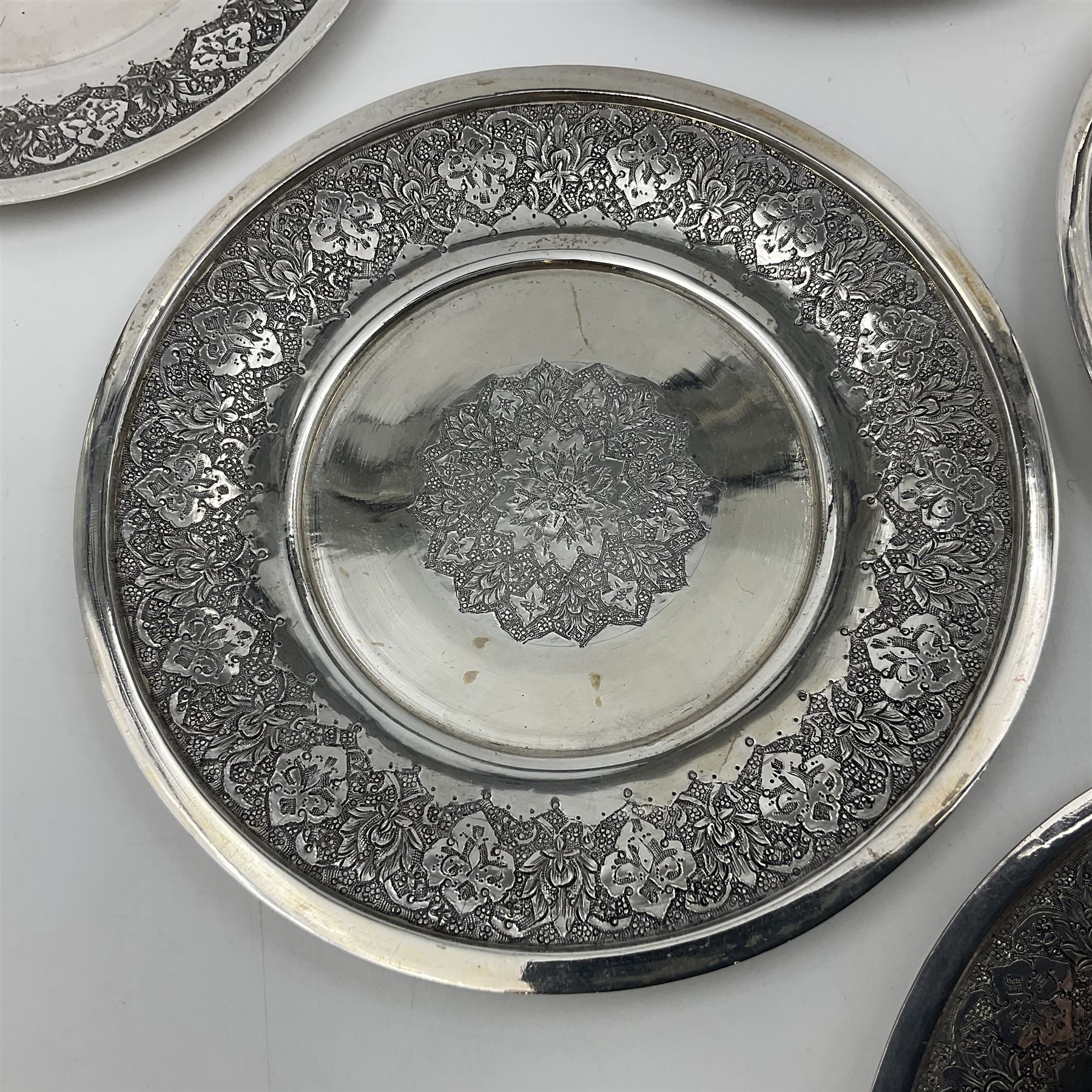 Early/mid 20th century Persian silver tea service, comprising circular serving tray, teapot, twin handled sucrier and cover, milk jug, five tea glasses with six silver holders, six tea spoons, and pair of sugar tongs, each profusely chased with foliate arabesque decoration, each bearing marks including 84 for 840 fineness, tray D40cm, teapot H16cm