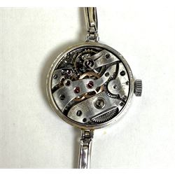 Audemars Piguet & Co Art Deco ladies platinum, diamond set manual wind wristwatch, movement No. 19931, cream / silvered dial with Arabic hour markers, the bezel milgrain set with round cut diamonds, to a platinum expanding bracelet