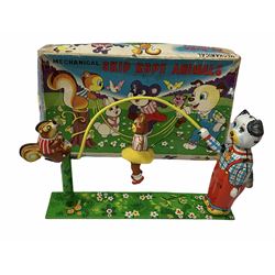 Gebruder Bing Germany Pigmyphone child's portable toy gramophone in woodgrain finish tin-plate box with key and tin of needles L15cm; and nine small records of nursery rhymes; together with a Japanese tin-pate 'Skip Rope Animals' clockwork toy, boxed.