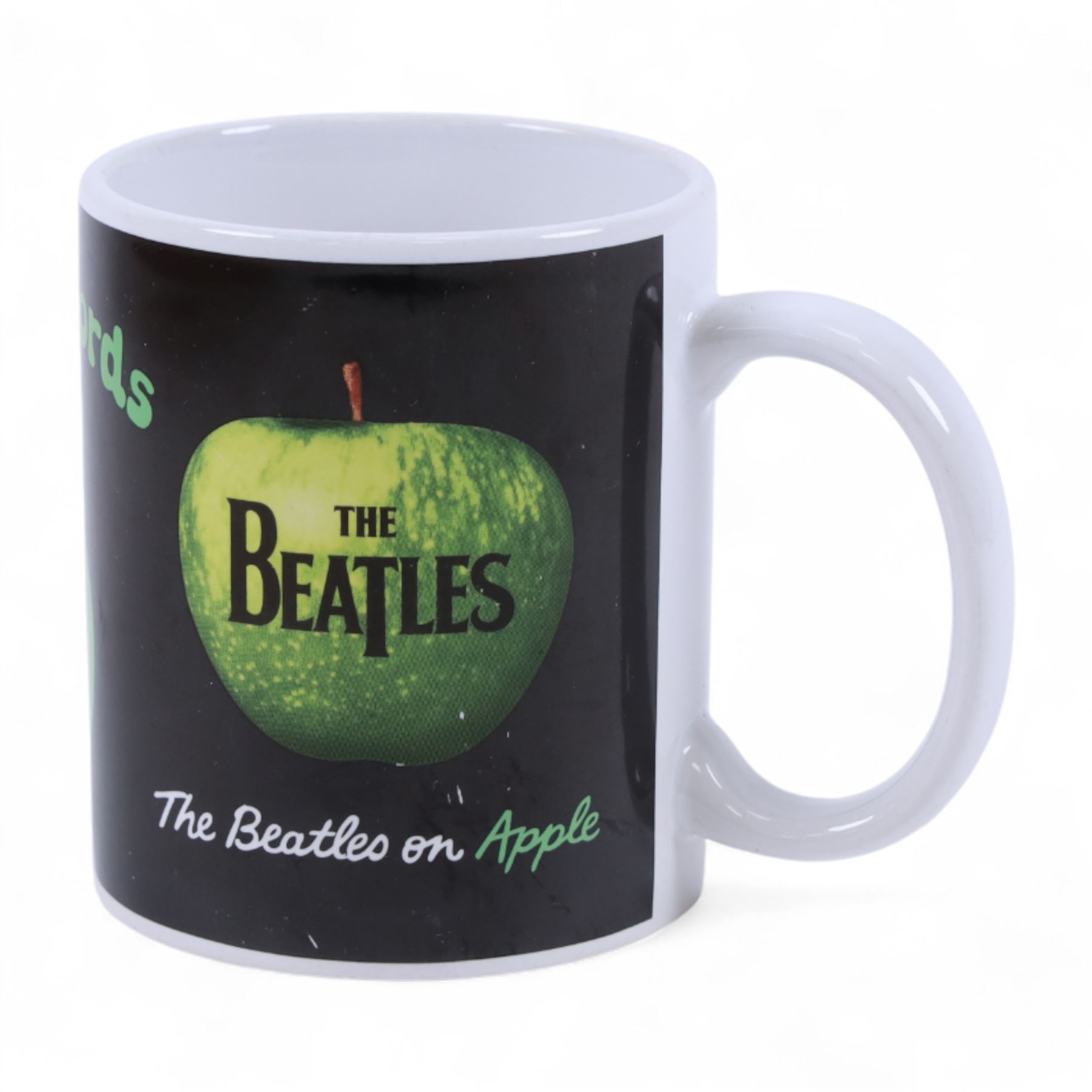 The Beatles memorabilia, including 1964 Fan Club patch, framed with a black and white picture of the band, a further framed black and white picture displayed with Strawberry Fields Forever single, The Beatles Anthology, biographies and other books, two CDs, mug, etc