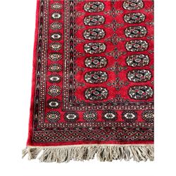 Tekke Bokhara red ground rug, decorated with two rows on Gul motifs, geometric design borders decorated with stylised floral motifs 