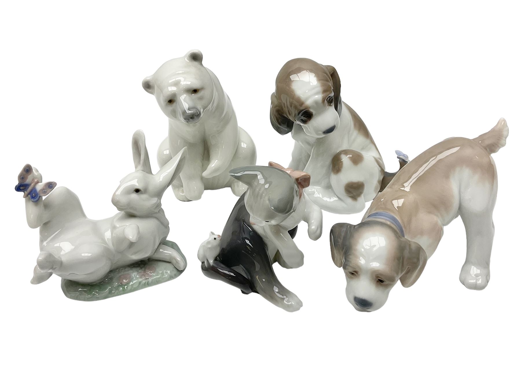 Five Lladro figures, comprising Cat and Mouse no. 5236, That Tickles no. 5888, Gentle Surprise no. 6210, Little Hunter no. 6212 and Resting Polar Bear no. 1208, largest H12cm