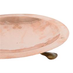 Arts and Crafts Birmingham Guild of Handicraft copper bowl, of circular form, the broad rim stamped with circles and fruiting sprigs, raised upon three cast brass feet, with impressed mark beneath The Birmingham Guild Ltd England, D30cm