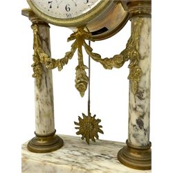 20th century French portico clock c1910 on a white veined marble base, gilt drum movement case supported between two marble columns with brass capitals and a suspended garland swag with a starburst pendulum beneath, enamel dial with Arabic numerals, floral decoration and Louis XV pierced gilt hands, convex glass and brass bezel, 8-day countwheel striking movement striking the hours and half hours on a bell. 




