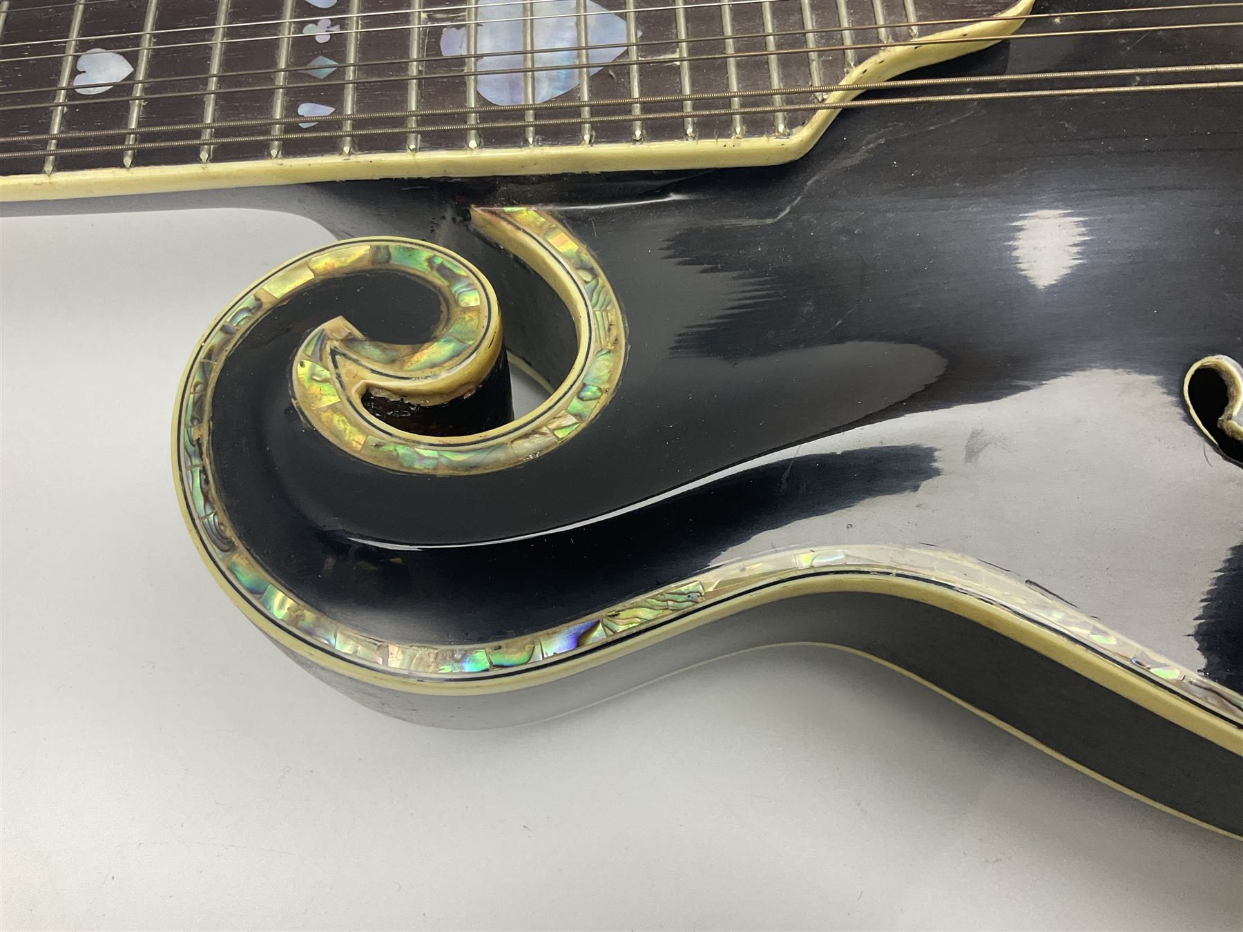 Eastern F-hole eight-string mandolin with black finish and mother-of-pearl inlay of a man riding a winged horse/unicorn amongst clouds and stars with playing card suits to the fingerboard L71cm