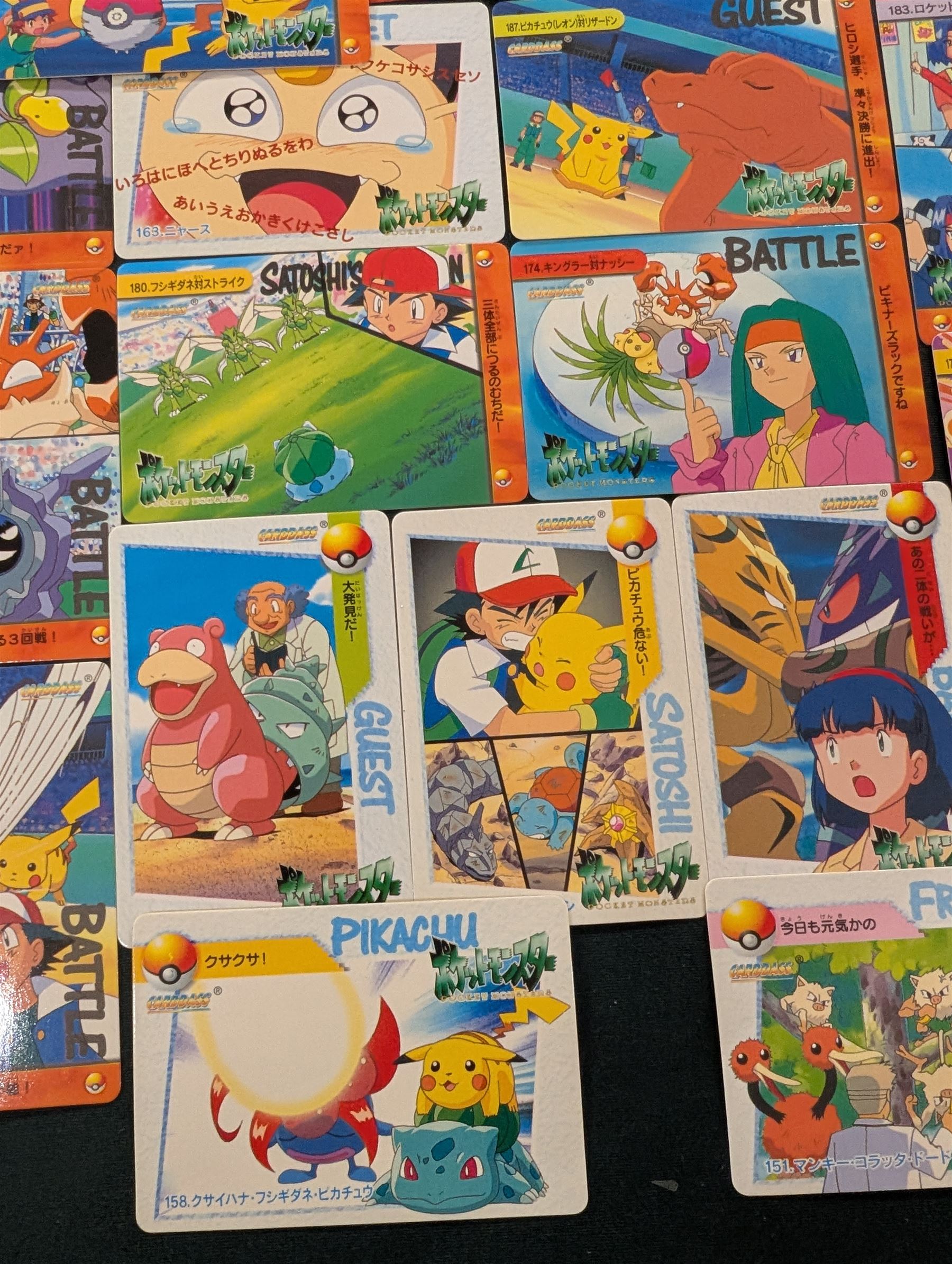 Collection of Pokemon TGC trading cards, including two WB First Movie Black Star promo cards Pikachu no. 4 and Dragonite no. 5, two Ancient Mew Black Star holo promo cards, Gym Challenge Giovanni's Persian 8/132 holo and a small collection WOTC, Neo Discovery and Neo Genesis cards, together with thirty four Bandai Carddass Pokemon cards, including prism Charizard no. 186 and Pokemon Topps cards including holo examples 