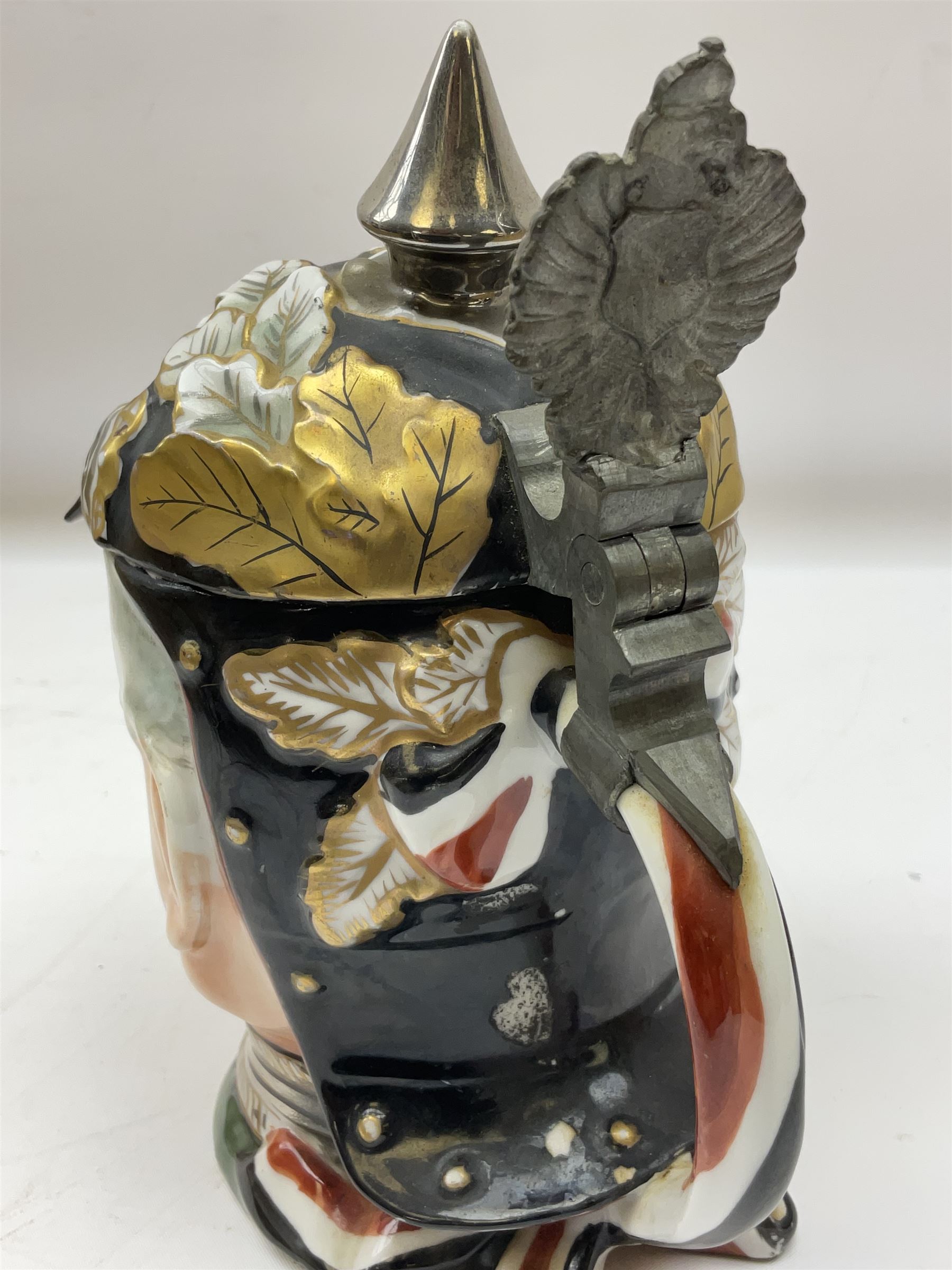 Otto Von Bismarck figural 0.5l stein, his black pickelhaube helmet with chrome spike serving as the lid, in green uniform and gilt detail throughout, pewter thumb hinge, with blue hash Musterschutz type mark, H18cm