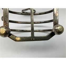 Silver plated seven bar toast rack of rounded rectangular form, raised on four bun feet, stamped A.W & Co., together with a sugar sifter spoon and copper kettle with brass handle and finial