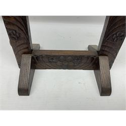 Chinese brass temple bell, decorated in high relief with a a dragon chasing a flaming pearl, within a carved floral hardwood stand, H36cm