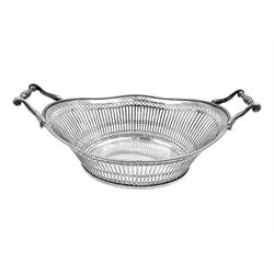  Early 20th century Dutch silver basket, of oval form with pierced sides, beaded rim, and twin handles, marked with Lion Passant for 2nd standard purity and date letter for 1910, other marks worn and indistinct, including handles H8.5cm L25.5cm