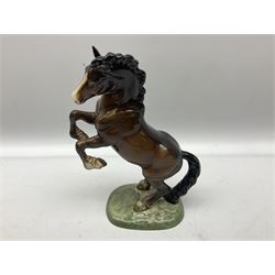 Three Beswick figure, comprising skewbald Pinto pony no. 1373, bay foal 'Another Star' no. 1727 and bay rearing horse no. 1014, all with printed mark beneath