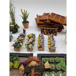 1:12 scale dolls house allotment and garden accessories, including wooden shed on a stone effect base, two vegetable patches, terracotta plant pots with flowers and foliage, stone effect plant pots, other planters, loose sunflowers, scarecrow, rabbit hutch, garden tools, fencing panels, etc 