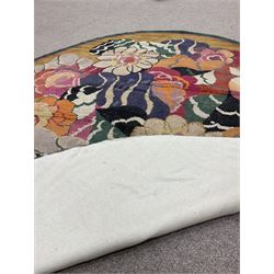 20th century wool oval rug, mustard ground and decorated with flower heads, with pink and green outer bands