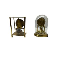 A 20th century English Torsion clock marketed by Bentime Ltd, London, with a four-ball rotary pendulum, white dial with gilt Arabic numerals and pierced gilt hands, under a glass dome, base with adjustable feet. No key.
Bentime Ltd did not make clocks but marketed clocks made by other companies such as J D Francis and Perivale.
H17
With a German Kundo torsion clock in a glazed rectangular case with four glass sides, four-ball rotary pendulum, white painted dial with gilt three-hour Arabic numerals and batons, with pierced brass hands. No key.
H15 W11 D9
