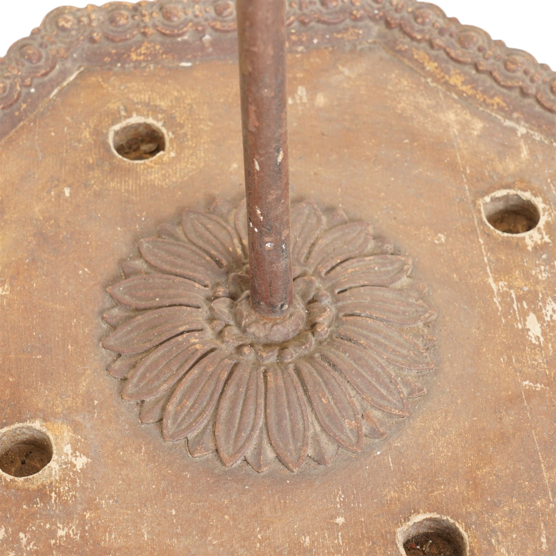 Victorian cast iron cane or stick stand, the top with a large loop lifting handle and floral design above geometric pierced decoration, central vertical rod, and octagonal base with lion paw feet