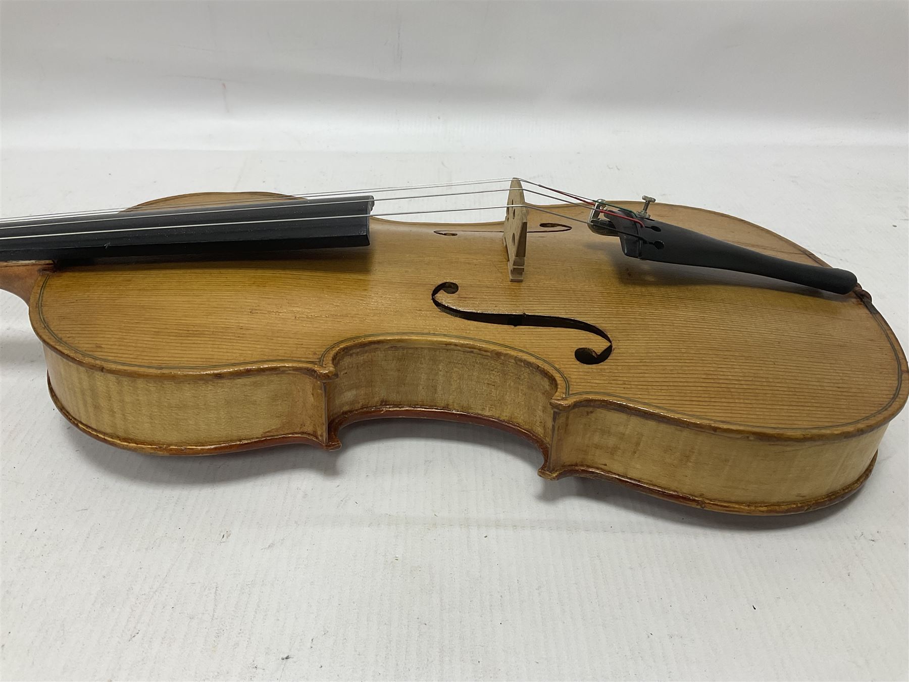 Copy of a full size Stradivarius violin, with an ebonised fingerboard, tailpiece and tuning pegs Length 60cm