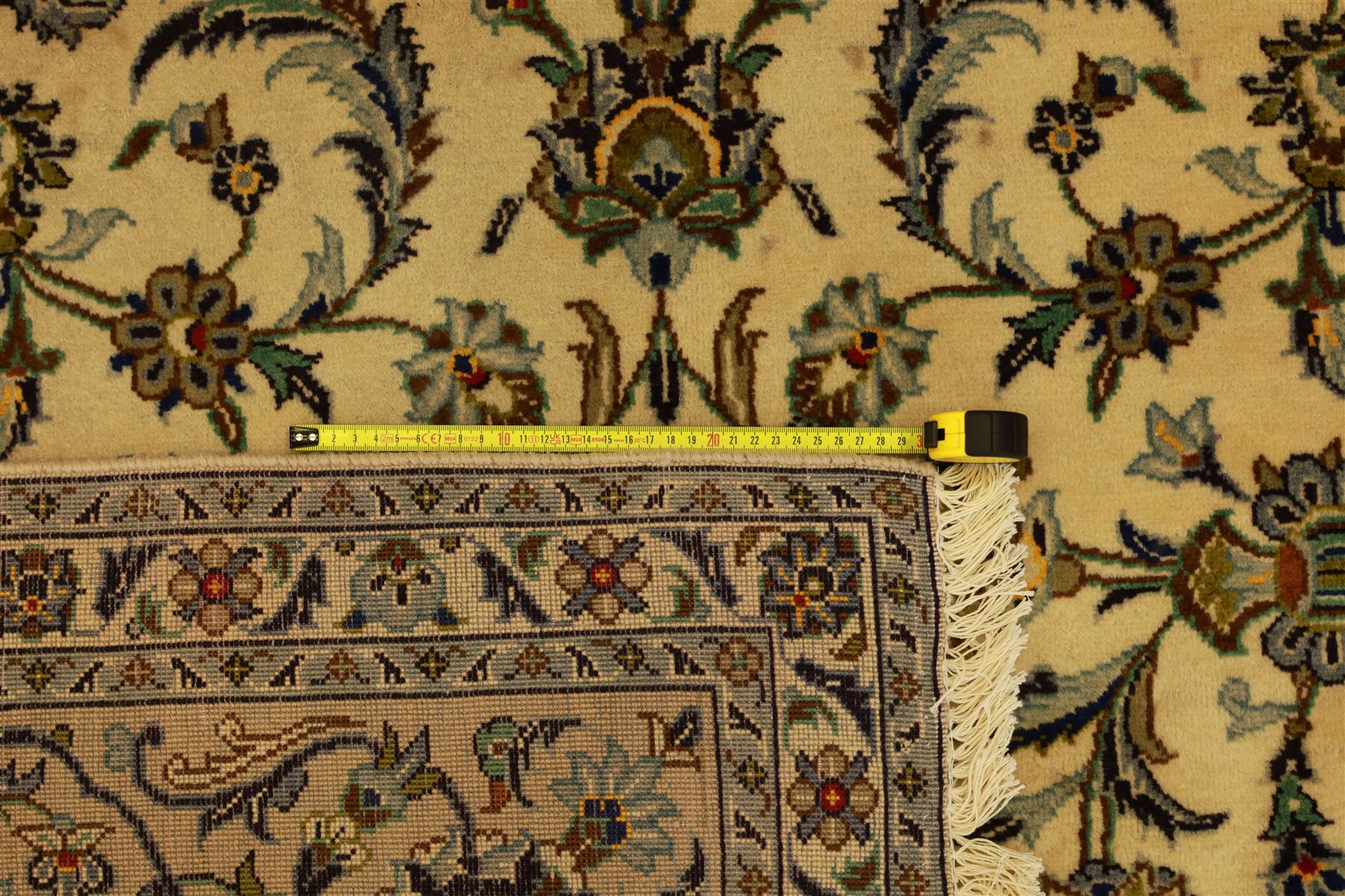 Central Persian Kashan carpet, ivory ground, field with an all-over design of scrolling palmettes and floral sprays in blue and terracotta within a beige ground and pale blue floral border