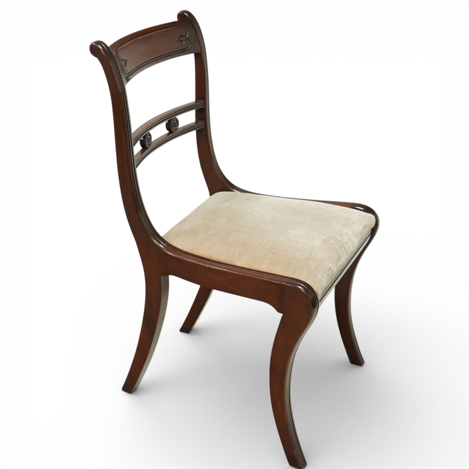 Arthur Brett & Sons - Regency design mahogany extending dining table and eight chairs, the oval top with rounded ends and two extension leaves, raised on twin pedestal supports with swept legs terminating in brass caps and castors, accompanied by a set of eight chairs comprising six single chairs and a pair of carvers, the chairs with curved backs and horizontal splat rails, upholstered seats, sabre legs and scrolling arms to the carvers
(Extends to 252cm)
(Chairs H 86cm, W 52cm)