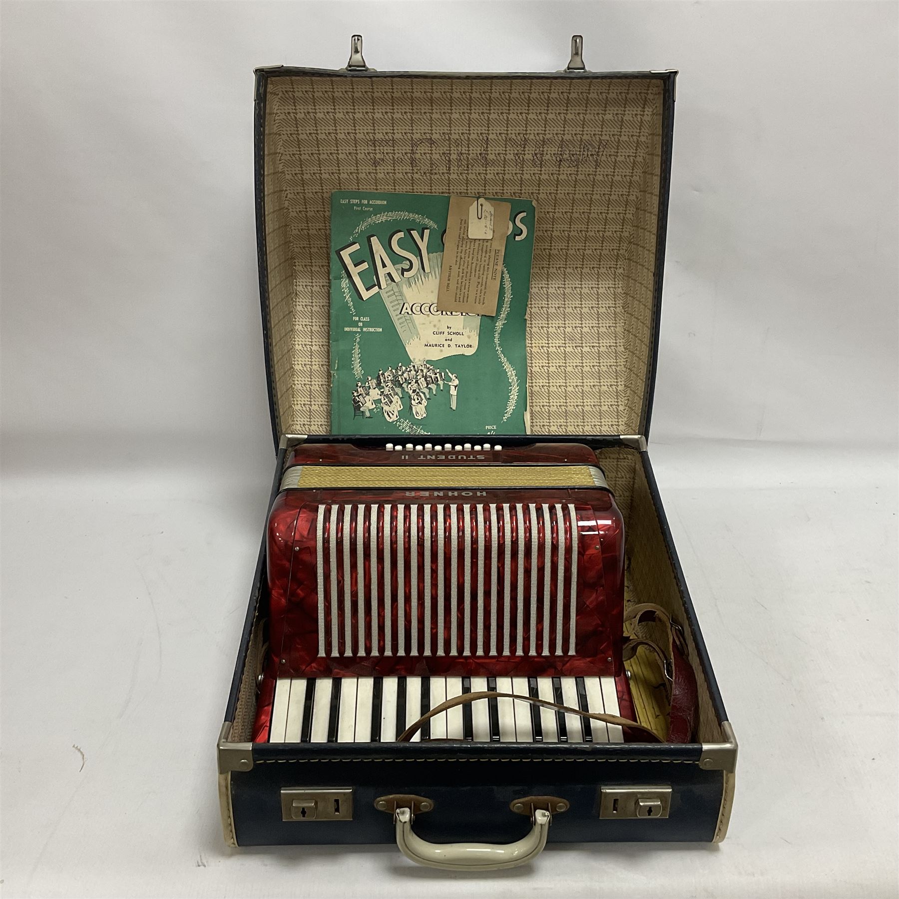 German Hohner student II compact accordion with 26 keys and 12 bass registers in a hard case With tutor