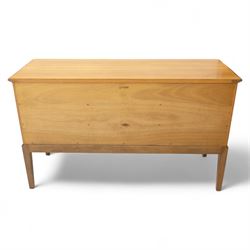Gordon Russell - mid century modern teak sideboard, the rectangular top with rounded edges over twin cupboards and three central drawers, fitted with circular wooden pulls, on tapered supports, reflecting the firm’s commitment to simplicity and quality materials during the post-war design period