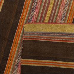 Flatwoven wool rug, with horizontal bands in dark brown, rust, ochre and muted red tones, detailed with narrow geometric patterned stripes across the field