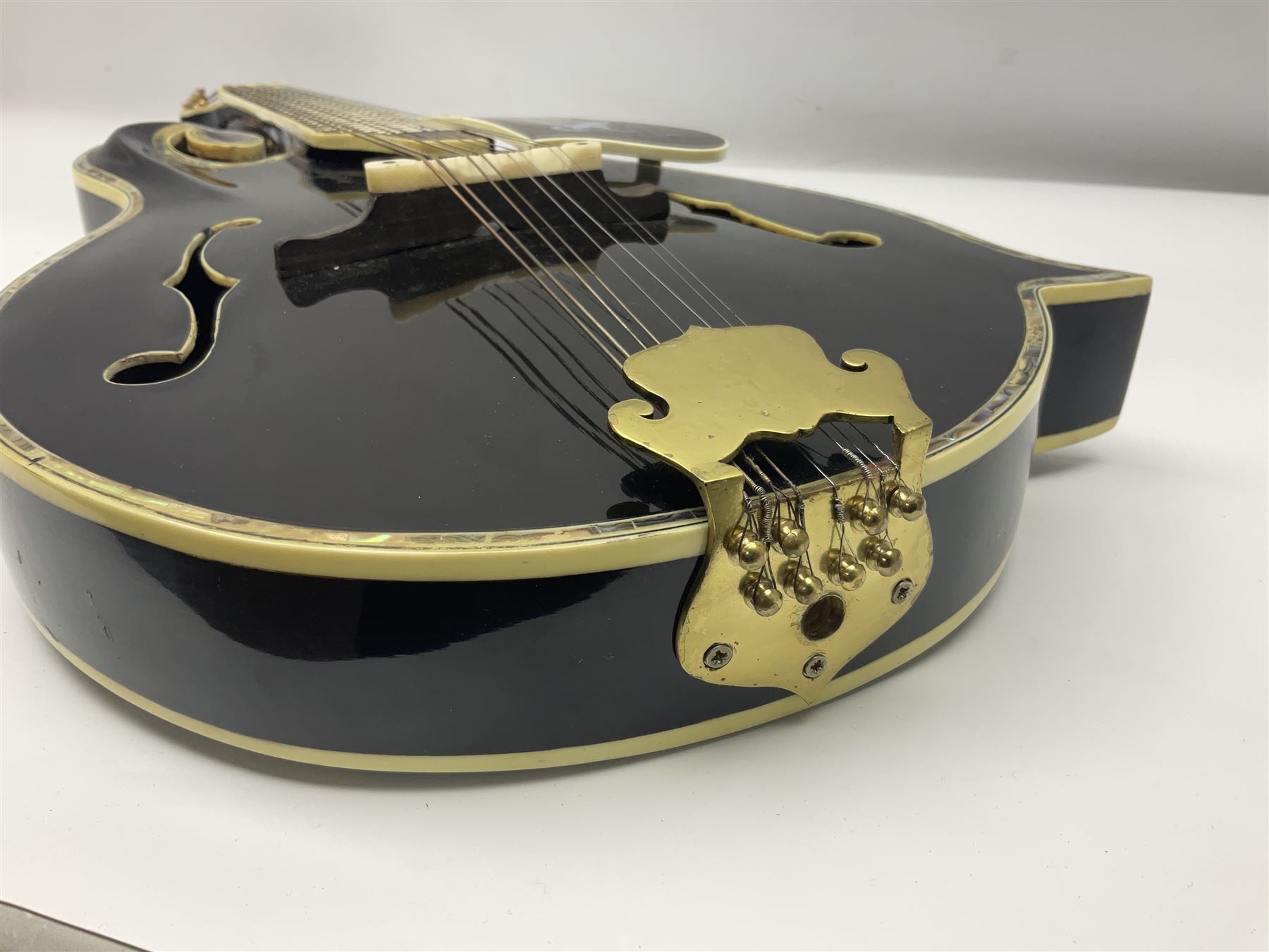 Eastern F-hole eight-string mandolin with black finish and mother-of-pearl inlay of a man riding a winged horse/unicorn amongst clouds and stars with playing card suits to the fingerboard L71cm