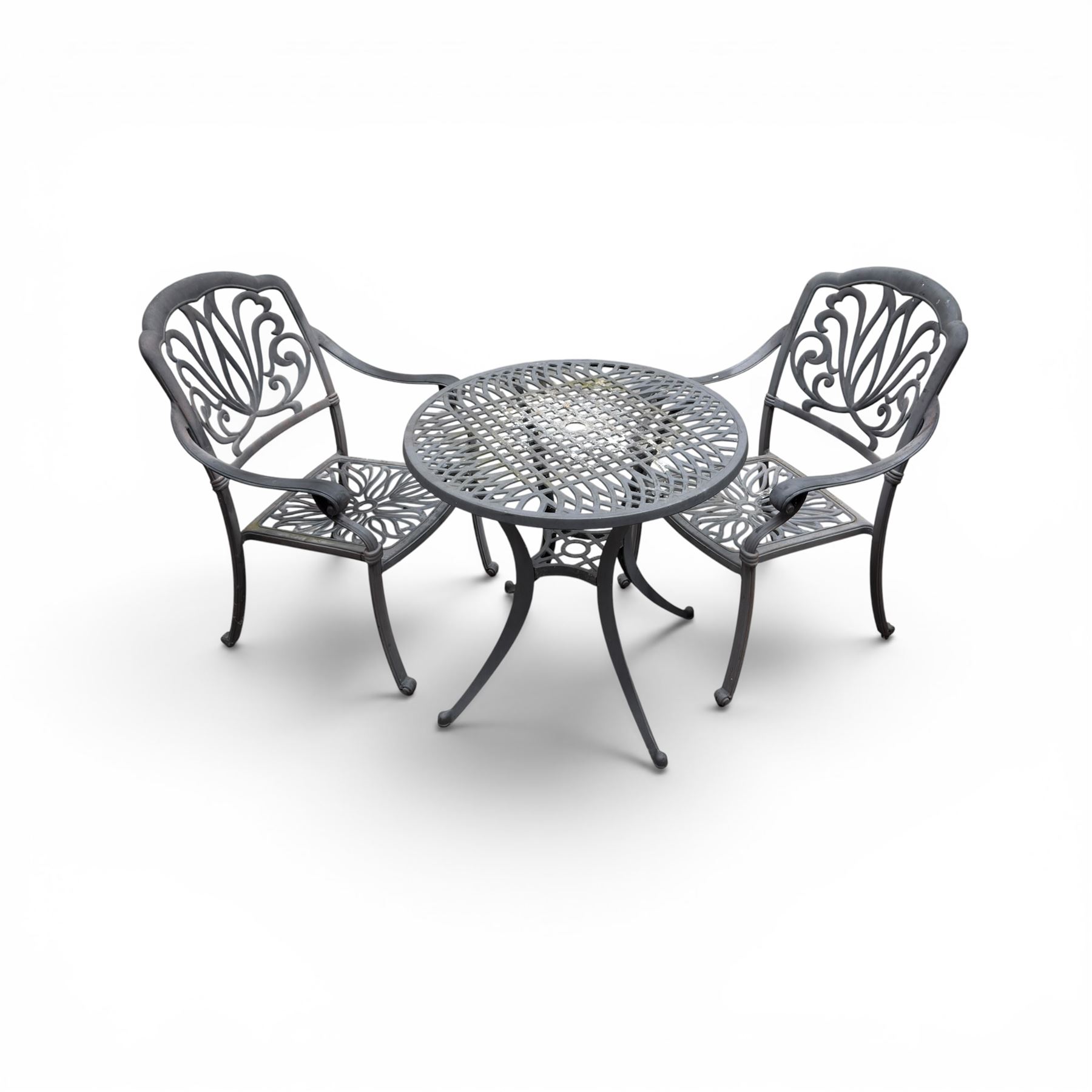 Circular aluminium garden table and pair of armchairs chairs with a pierced and scrolling backs 