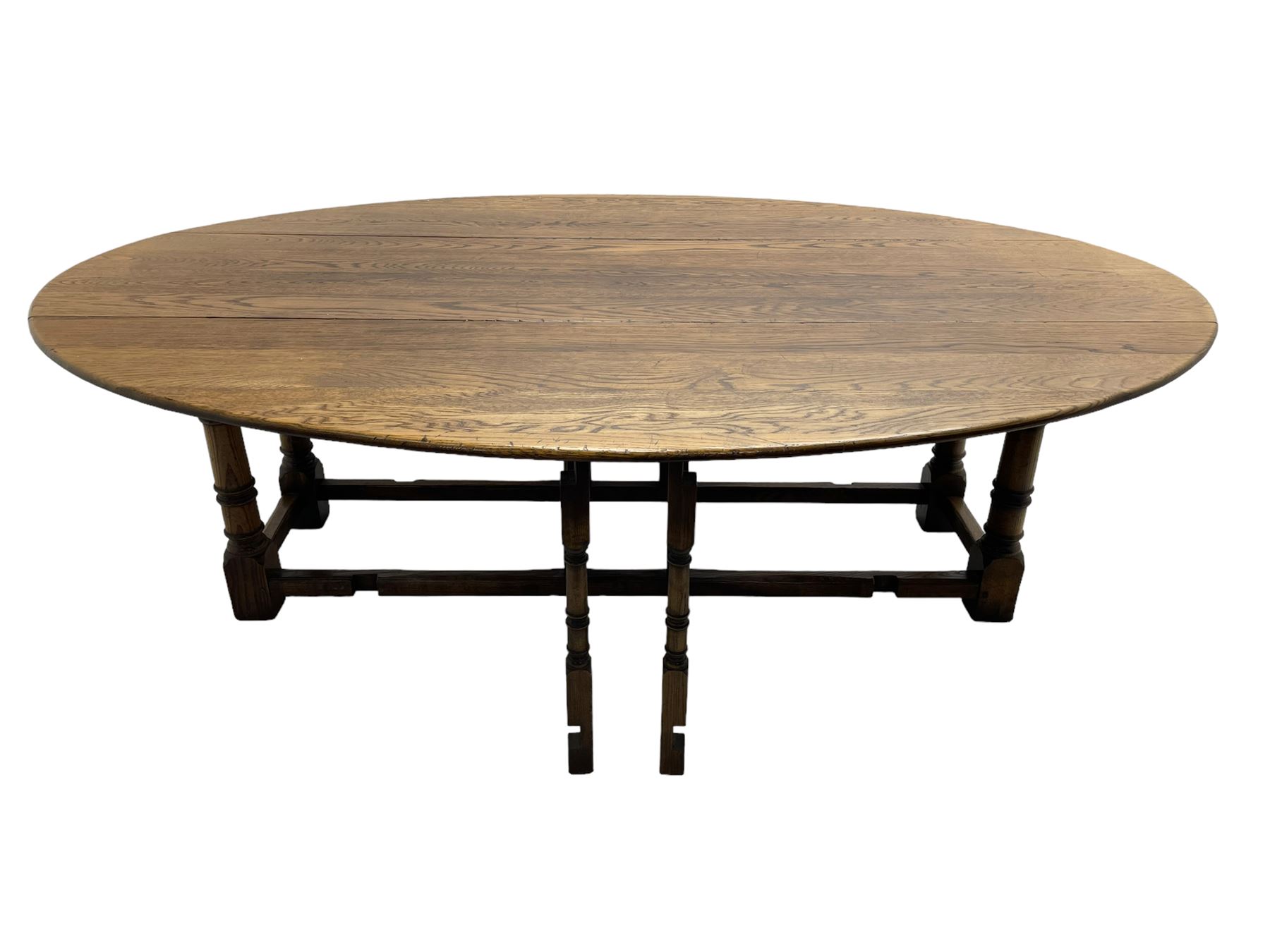 Large 18th century design oak wake or dining table, oval drop-leaf top, turned supports with double gate-leg action base, united by moulded stretchers 