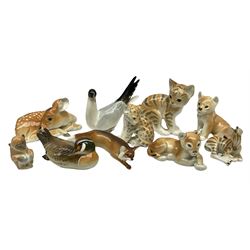 Group of Russian USSR animal figures by Lomonosov, to include examples modelled as an outstretched hunting fox, kitten, lion cubs, seagull/tern etc, all with stamped marks beneath, together with a model of a recumbent deer with no marks, tallest H14cm