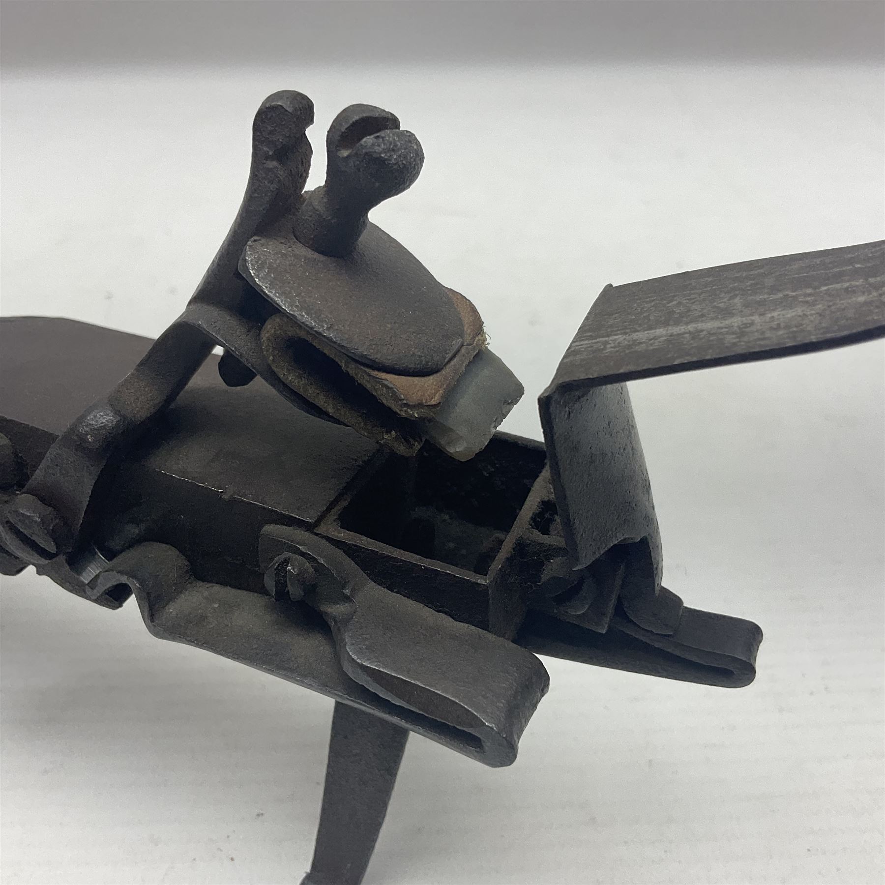 Late 18th/early 19th century flintlock tinder lighter, the steel box lock with hinged door to the left side, fruitwood butt with plain bar trigger, the left side set with a taper sconce and bipod front support, L21cm.