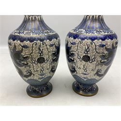 Pair of Cloisonne vases of bulbous form, decorated with dragons chasing flaming pearls amongst clouds, H24cm