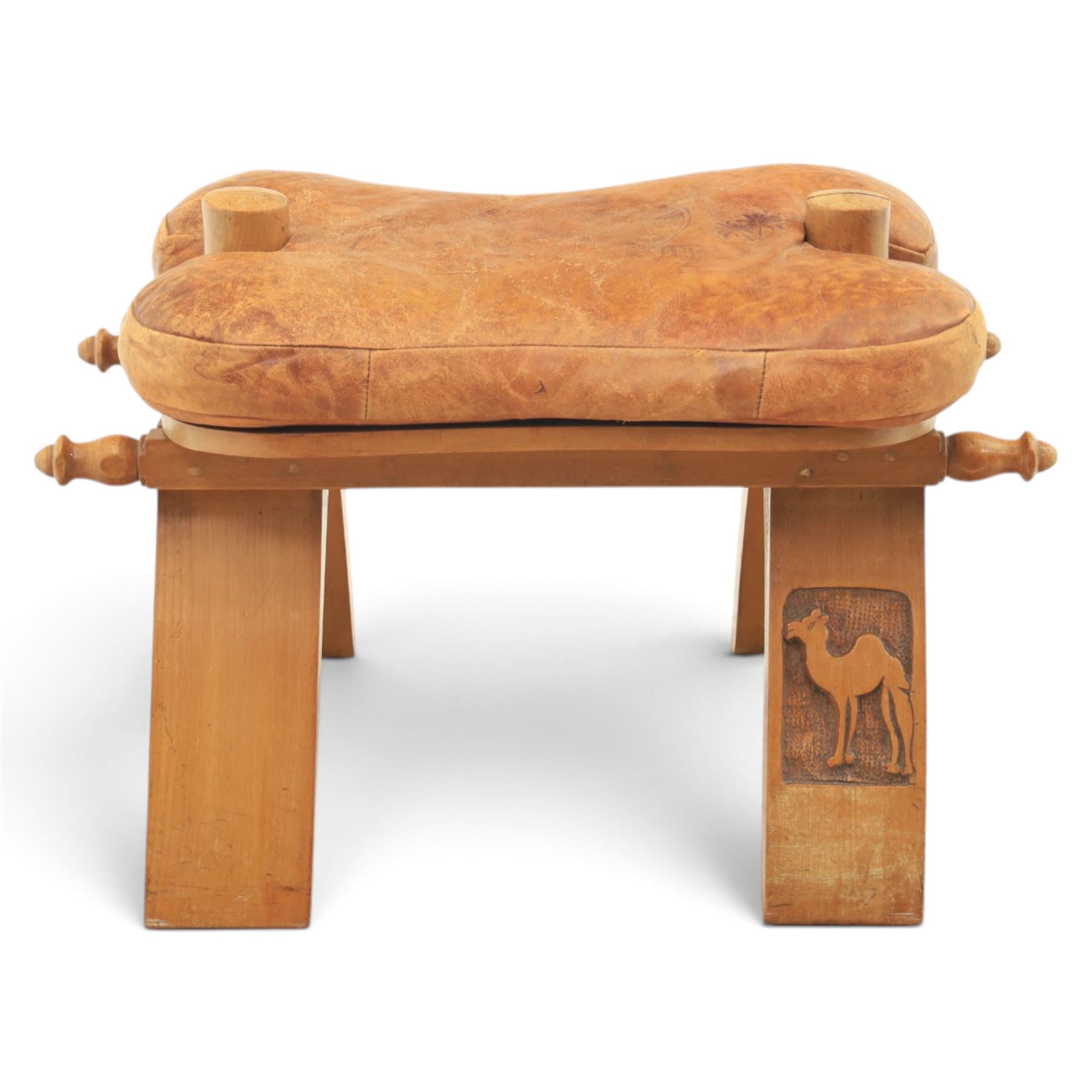 20th century Camel stool, tan leather seat with tooled design, raised on a light wood carved frame with camel design