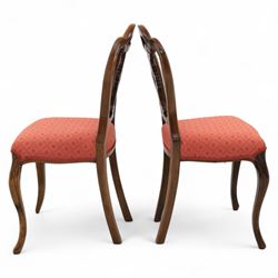 Set of four Victorian walnut balloon back chairs, with a carved and pierced back splat with foliate scrolls, serpentine seat upholstered in a diamond pattern fabric, raised on cabriole legs 