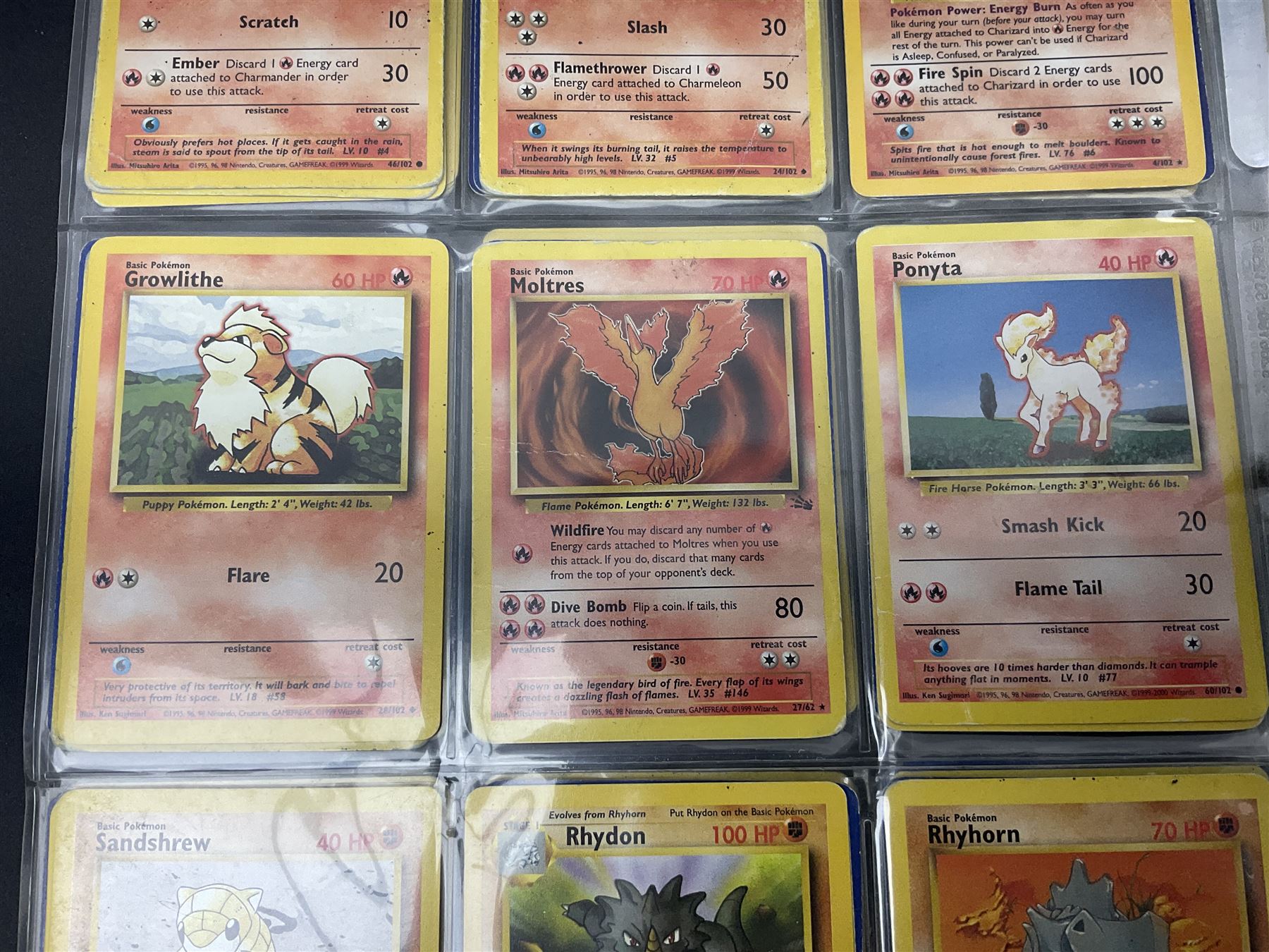Collection of Pokemon trading cards, mostly 1999 Wizards Pokemon cards to include holo Charizard 4/102, first edition holo Machamp 8/102, further holographic cards; Dark Flareon 35/82 and Dark Vaporeon 45/82, cards from themed sets and 4th edition prints; 1998 Electronic Pokédex with cardboard boxes for themed decks Blackout, Overgrowth and Power Reserve Jungle, along with a large quantity of energy and trainer cards 
