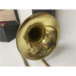 Three brass trombones comprising Elkhart Ind. USA 'CONN' model no.72H; Besson 'Concord'; and Selmer Distributed 'Lincoln'; two in carrying cases; and German B & M 'Champion' brass trumpet (4)