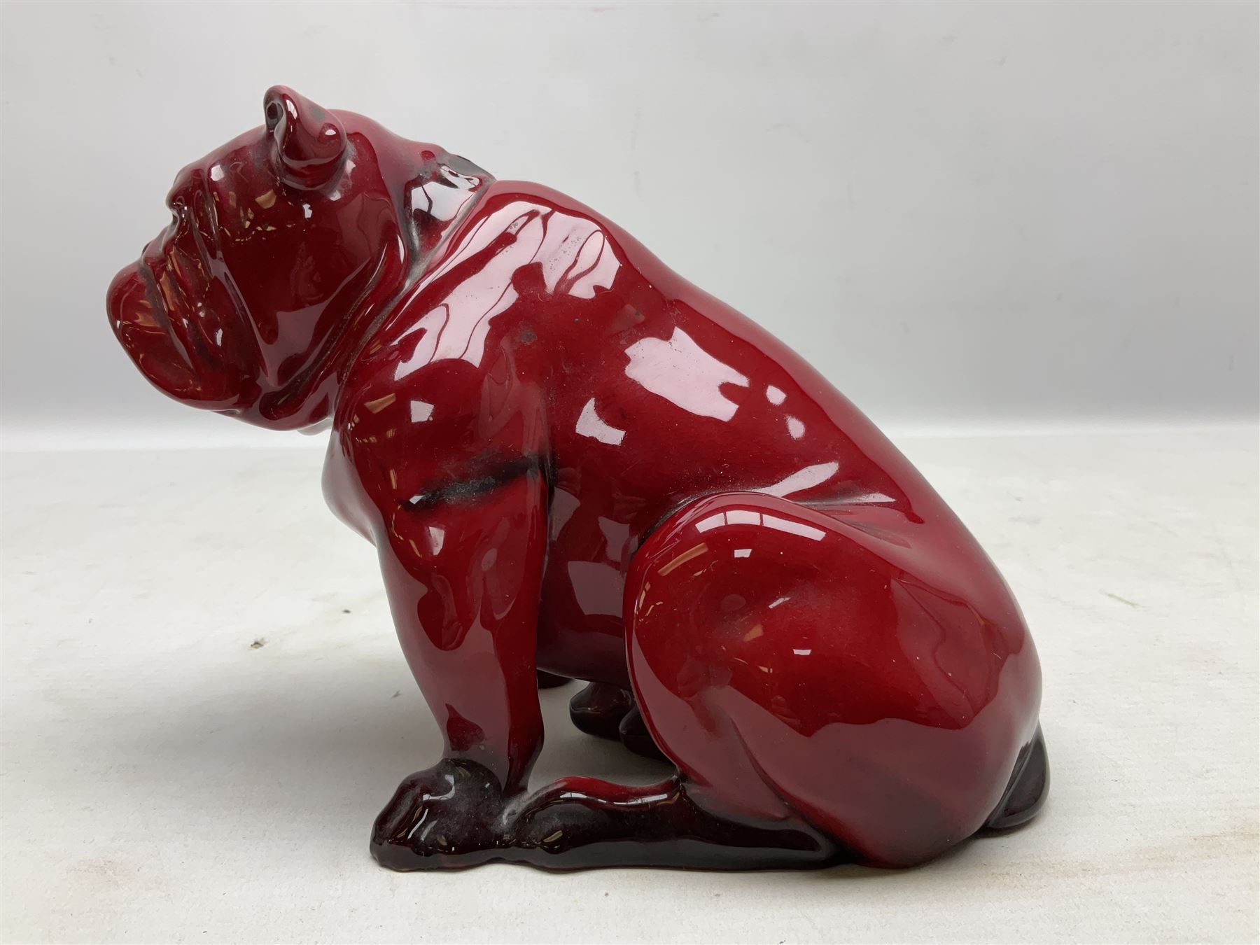 Royal Doulton Flambe figure of a Bulldog, modelled seated, model no 135, with printed maker's mark and K and impressed 135 beneath, H13.5cm
