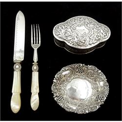 Victorian silver lidded trinket box, with embossed decoration by John Edward Wilmot, Birmingham 1900, silver bladed knife and fork with mother of pearl handles by Atkin Brothers, Sheffield 1862 and an embossed silver dish hallmarked (4)