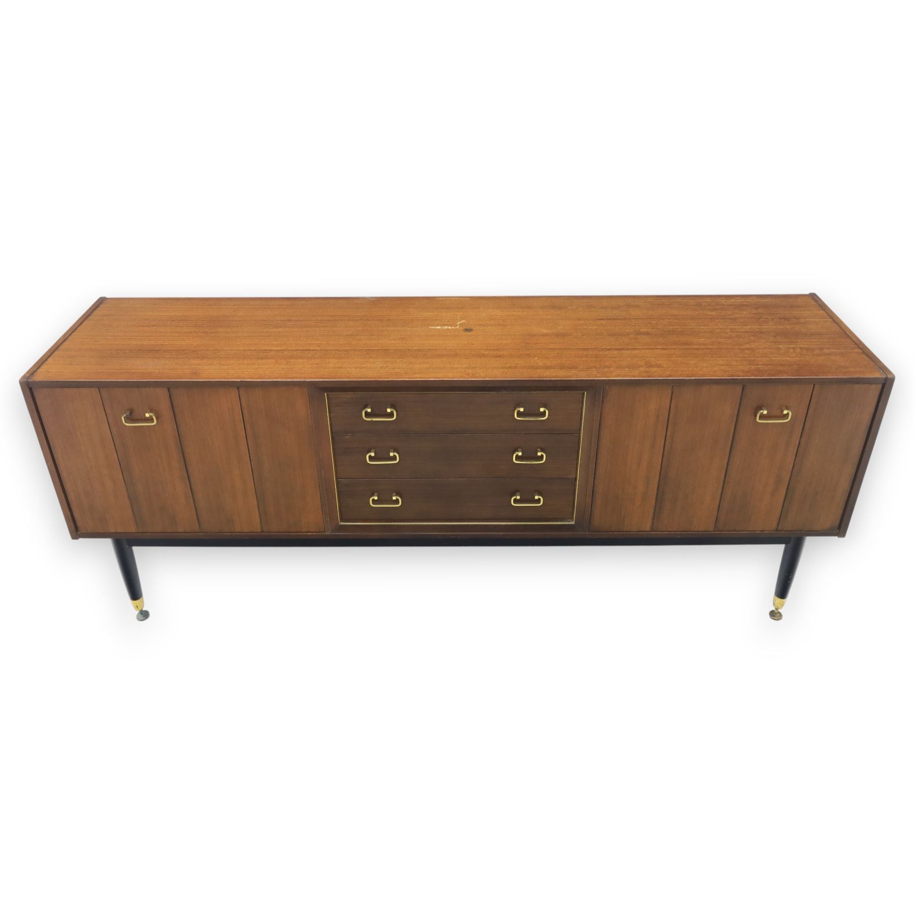 G Plan - ‘Librenza’ tola wood sideboard, the rectangular top above two cupboards to either side and three graduated central drawers, the drawer and door fronts veneered in figured tola wood with brass handles, standing on splayed tapering legs