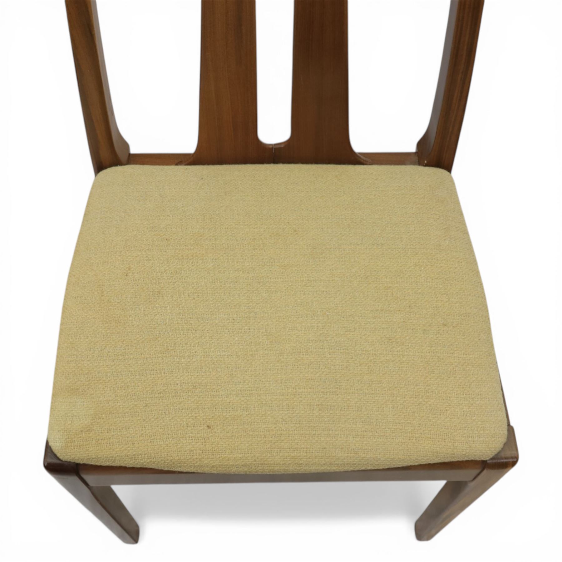 Nathan - teak drop leaf dining table and four Nathan dining chairs, the rectangular top with rounded corners fitted with twin hinged drop leaves and gate legs, extended to form an oval table 174cm in length, raised on square section supports united by stretchers, the chairs with teak frames and padded beige upholstered seat (H 96cm, W 48cm)