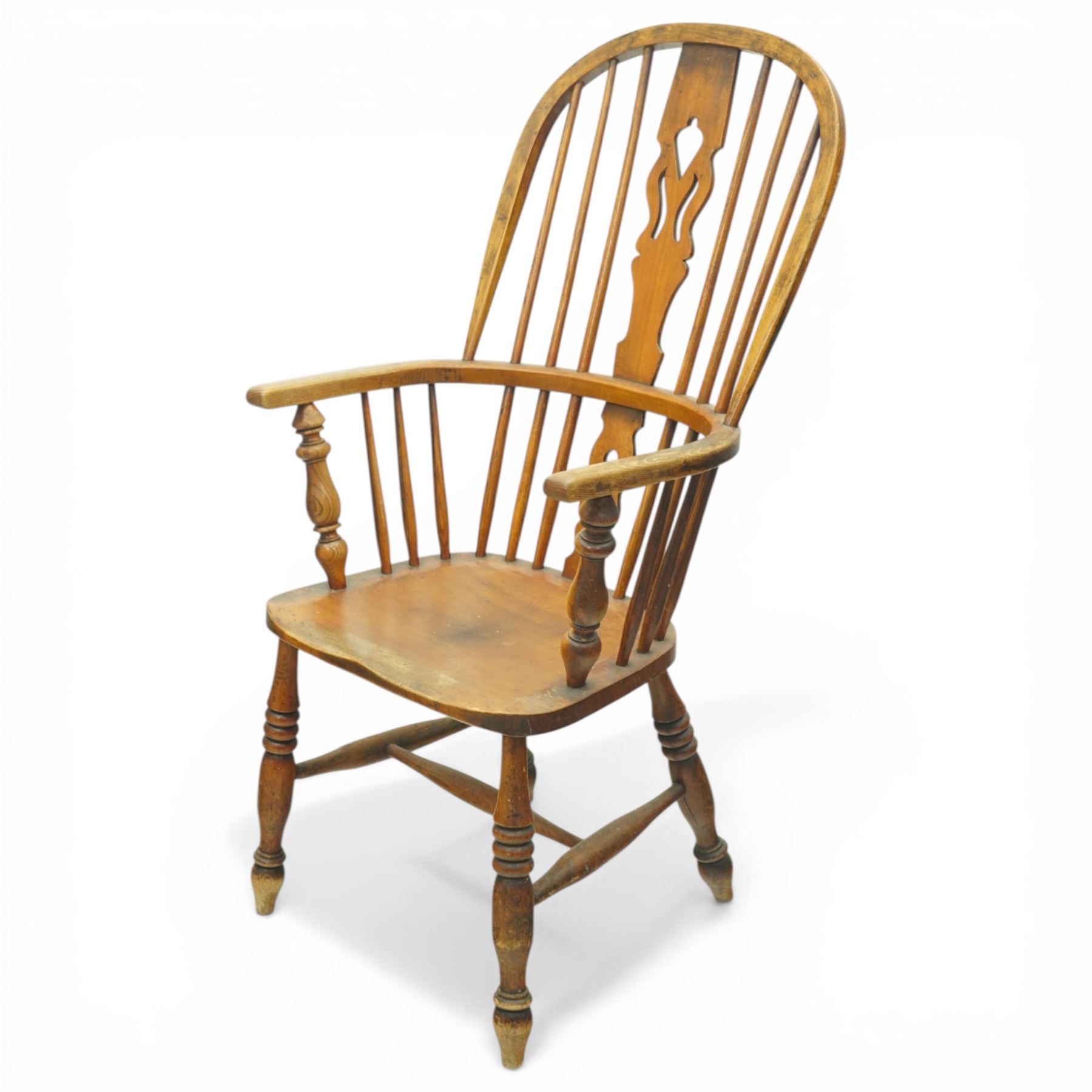 Set of two late 19th century elm and beech Windsor armchairs, each with hoop backs and turned spindles, shaped central splats, solid seats and turned supports united by H-stretchers