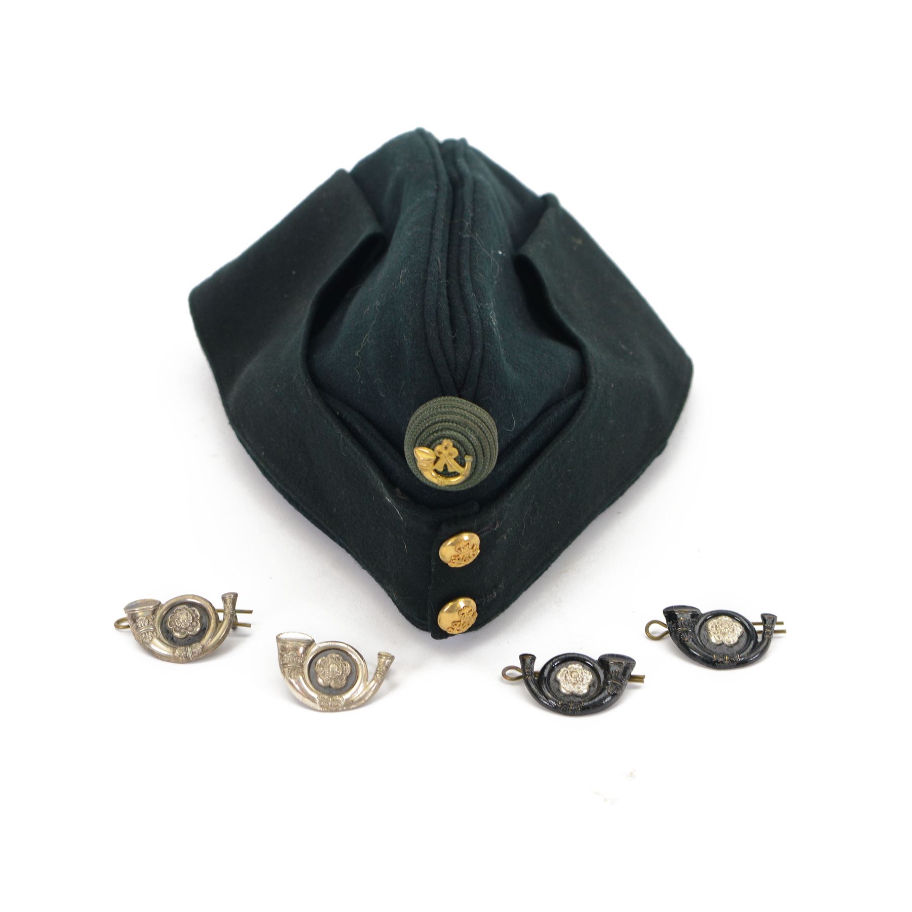 Kings Own Yorkshire Light Infantry field service cap, with brass KOYLE buttons to the front, the bollion with light infantry badge, with label inside for Chas. C. Whitelock Ltd; Name G. Black Esq Date July. 1964,  together with two sets of KOYLE cap badges 