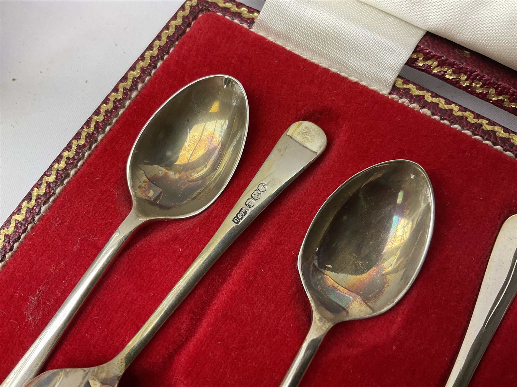 Set of six 1960's silver coffee spoons, hallmarked Sheffield, contained within a fitted case with interior inscribed Harrods, together with a silver napkin ring, hallmarked Birmingham, and a silver plated photograph frame, approximate silver weight 68.4 grams