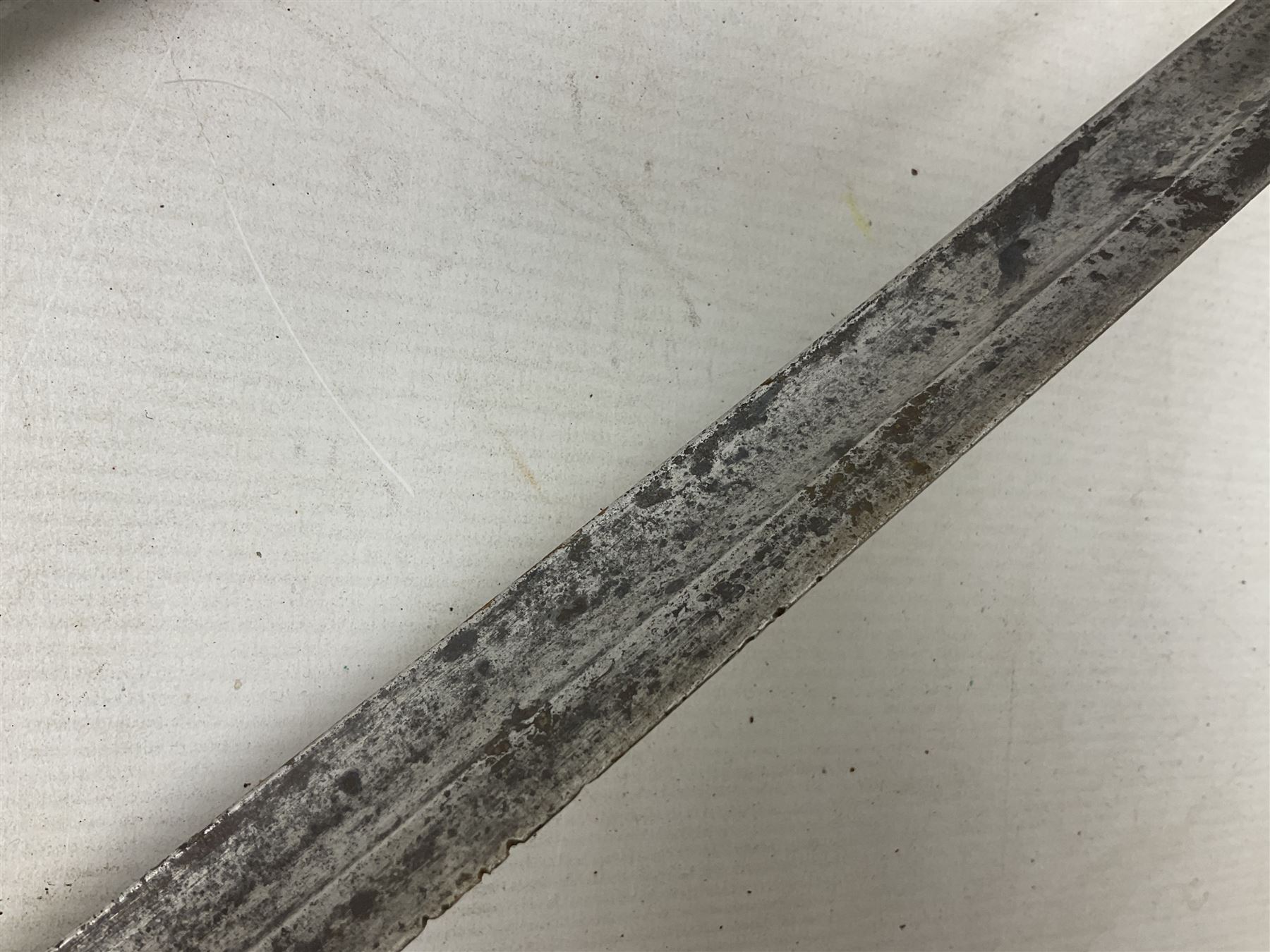 George V British Army 1897 pattern officers sword with plain 82cm fullered steel blade, pierced  basket hilt with George V cypher and wire bound leather grip with chequered backstrap; in leather covered field service scabbard L101cm overall; and another officer's sword in relic condition lacking scabbard (2)