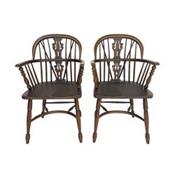 Pair late 20th century oak Windsor elbow chairs, double hoop and stick back with pierced and fretwork work splat, dished seat on turned supports joined by crinoline stretcher