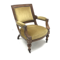 Late Victorian armchair upholstered in yellow fabric, shaped cresting rail, carved cup and cover supports, W71cm